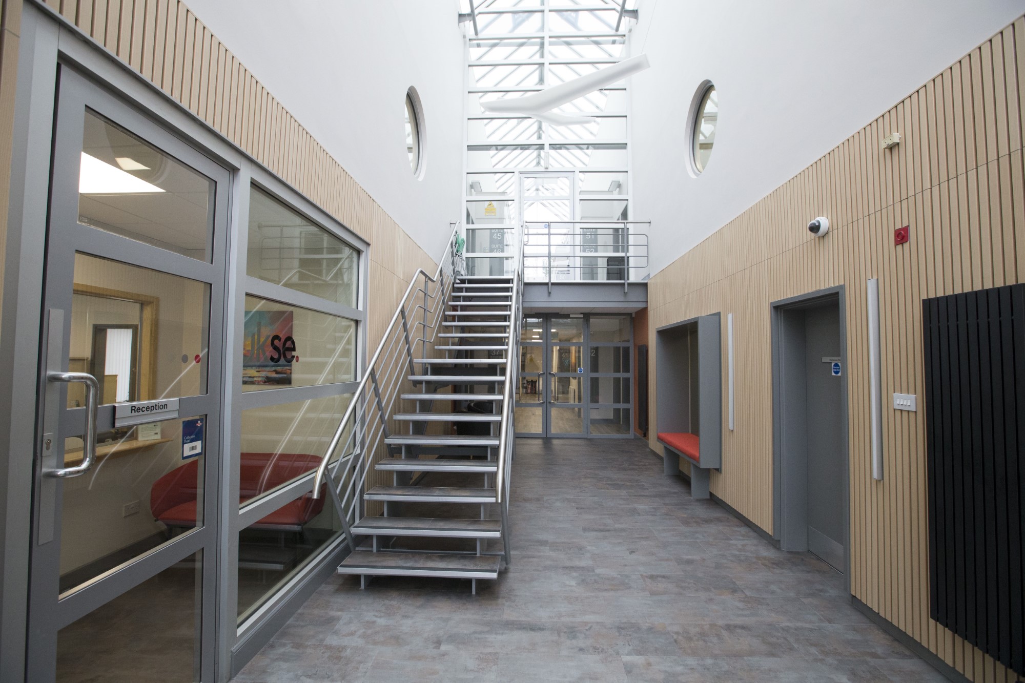 A hallway next to the reception which is lined with office spaces to rent at the Strathclyde Business Park