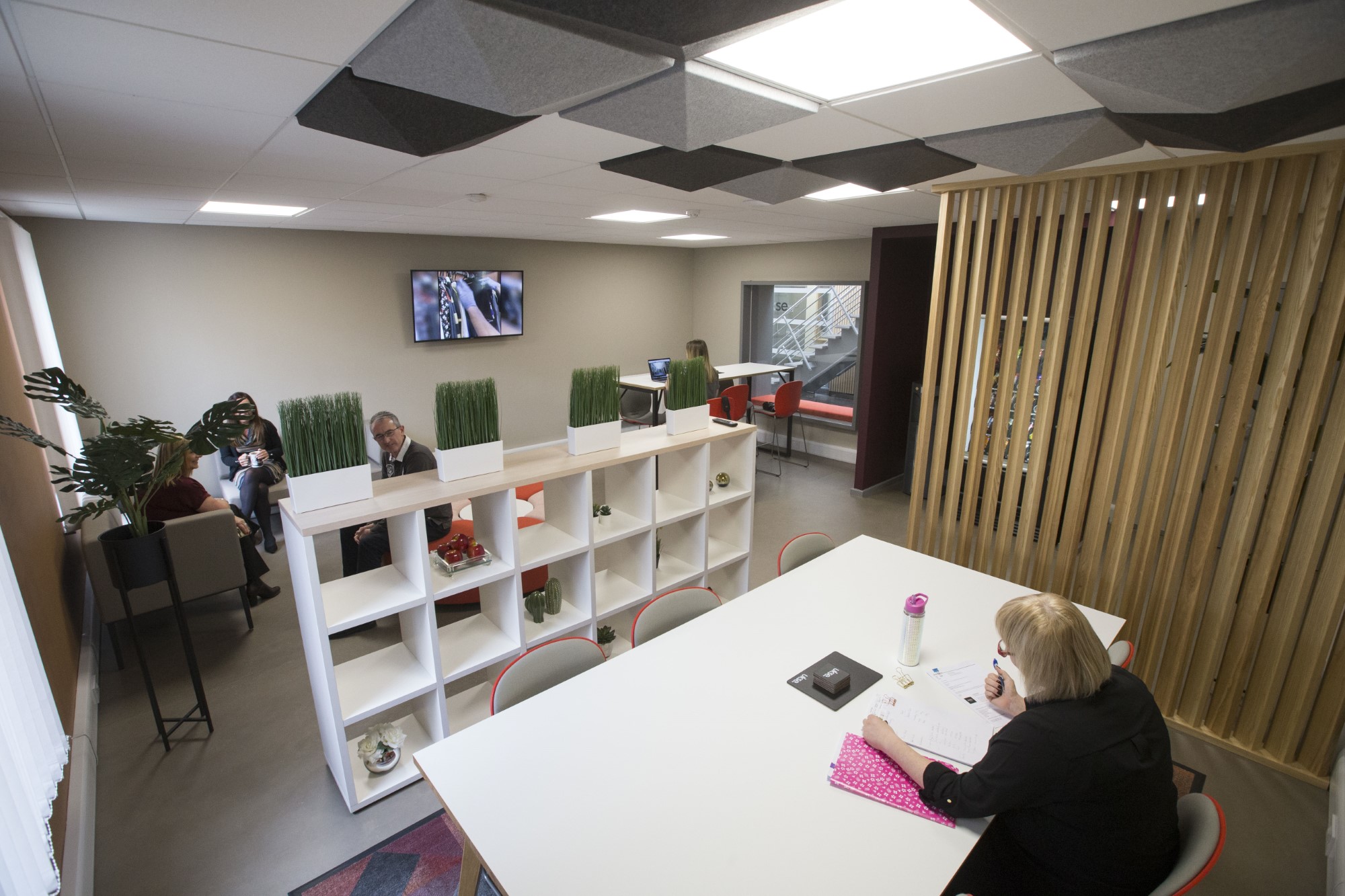 Seating area with decorated shelving space inside UKSE's offices to rent
