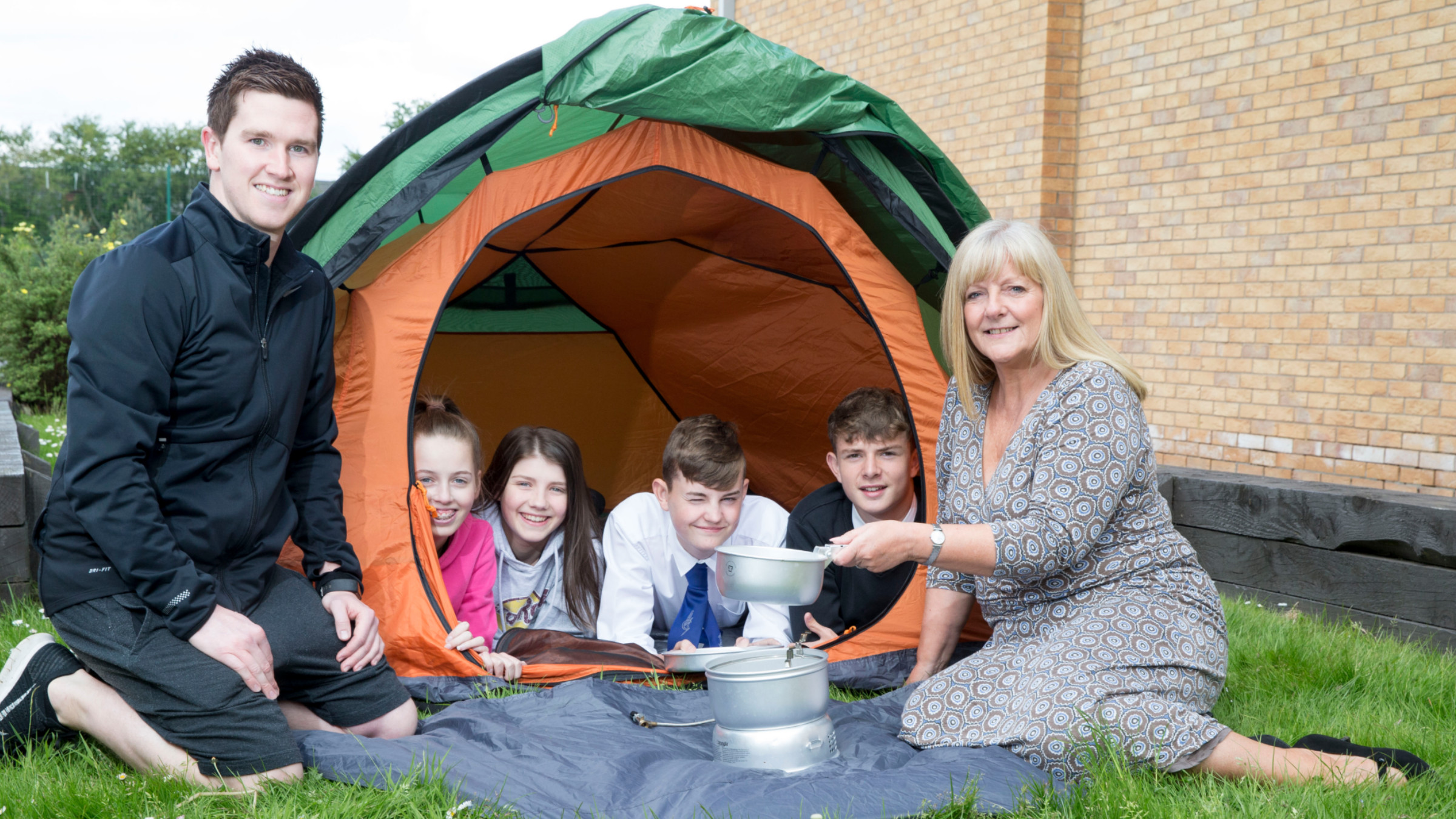 Anne Clyde UKSE and Craig Strachan with four Duke of Edinburgh pupils in a tent using a camp stove