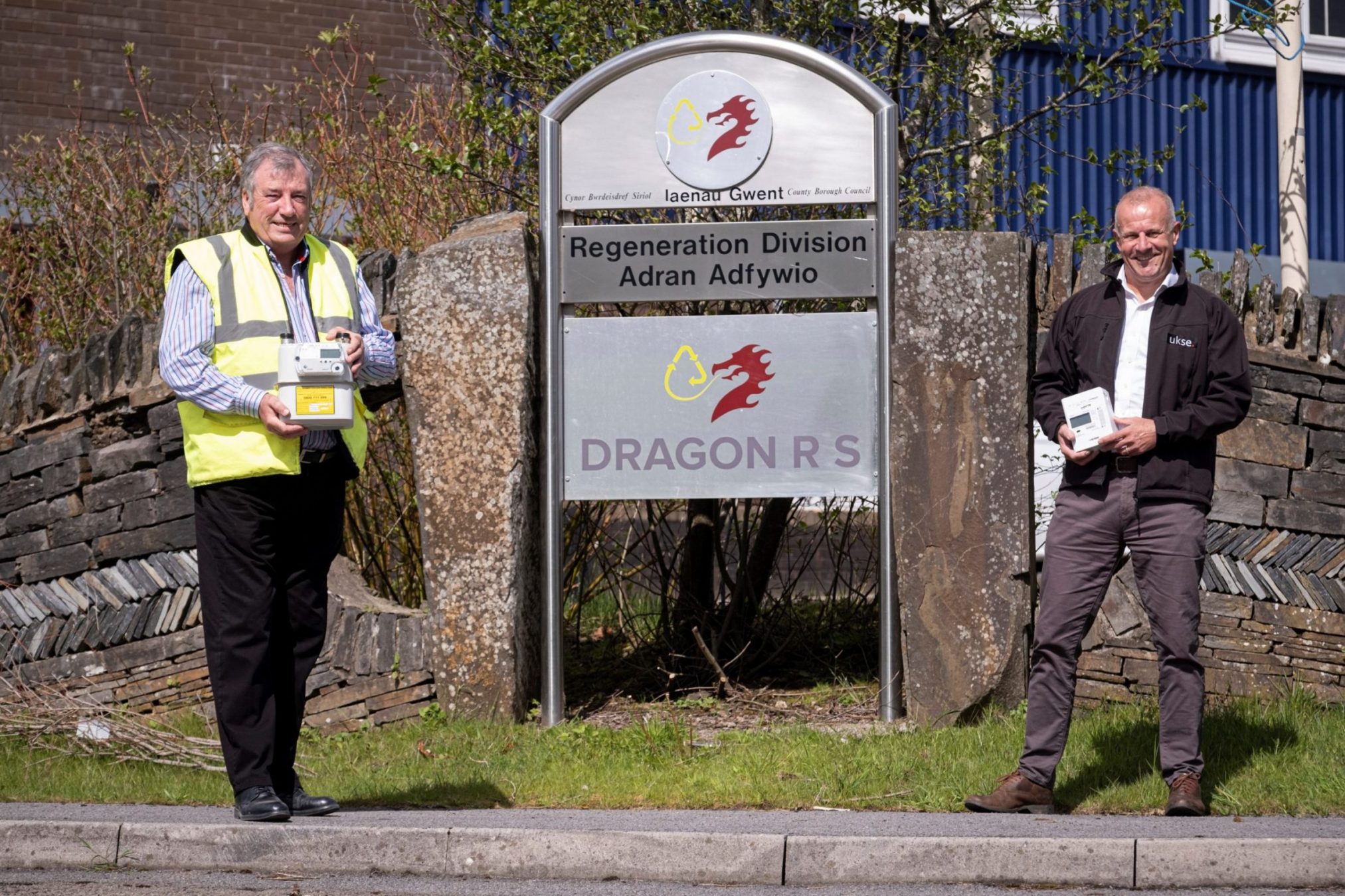 Mick Young from Dragon Recycling Solutions and Martin Palmer from UKSE stood outside in front of Dragon RS's business sign