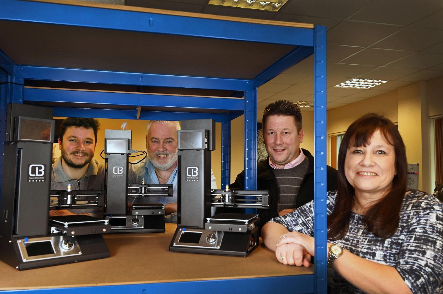Four employees of Copner Biotech who recently moved into one of UKSE's workspaces with their Inkjet Bioprinter